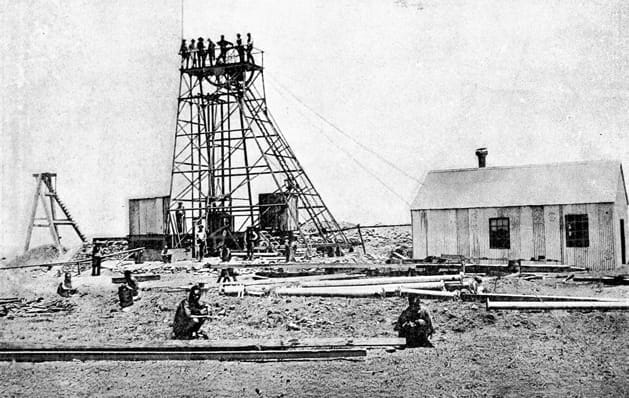 Black-and-white photo of an old mining site captured by a professional tours specialist