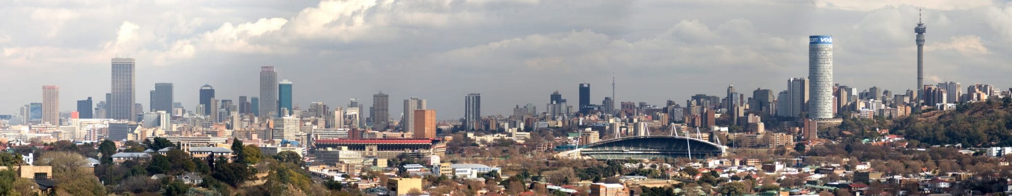 Panoramic view of Johannesburg skyline with tall office buildings, the iconic Ponte City tower