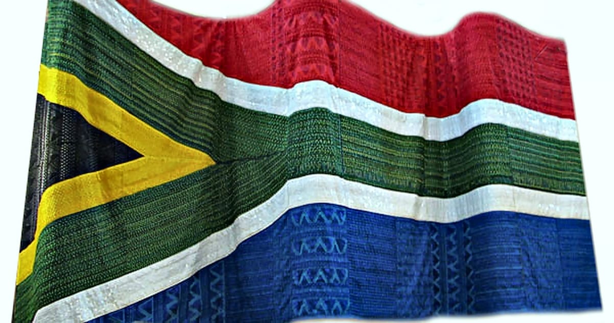 The image shows the South African flag made from woven fabric