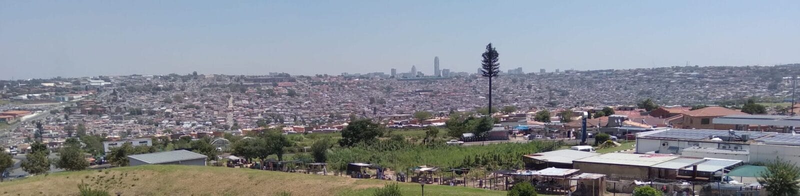 Panoramic view of a densely packed urban area with small buildings and shacks