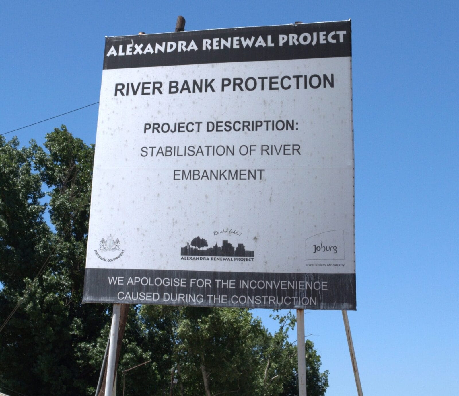 Large white sign reading "ALEXANDRA RENEWAL PROJECT. River Bank Protection. Project Description
