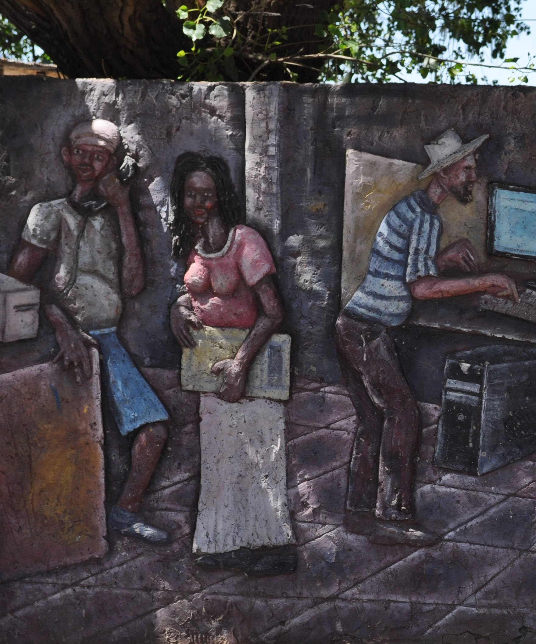 A textured mural depicts three figures: a man talking on the phone, a woman in a pink top holding a folder, and a man in a hat working at a computer. The scene is set against a greyish wall with a tree overhead.