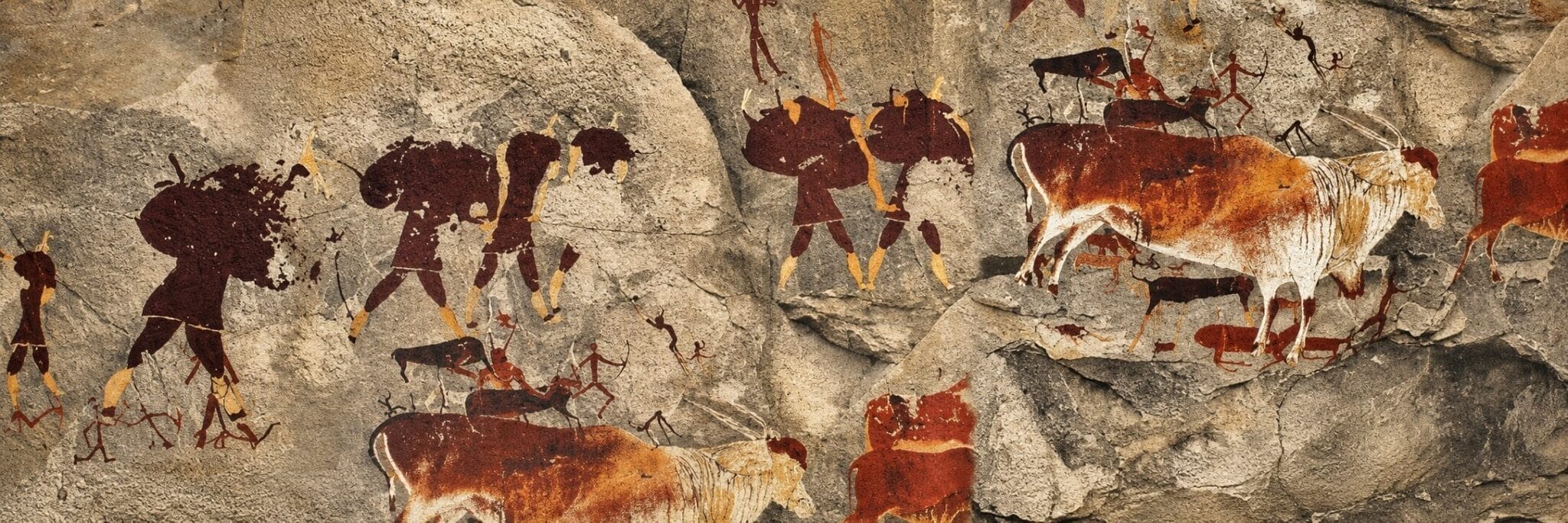 Cave painting on rough stone shows human figures with bows and spears hunting large animals